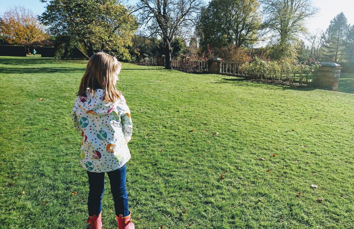 girl looking out over a garden